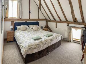 a bedroom with a bed with a blue head board at Rumbolds Retreat in Plaistow