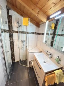 a bathroom with a shower and a sink at Chalet Stadel in Saas-Grund