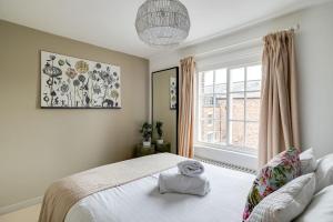 a bedroom with a bed and a large window at Gamul Place - Quiet City Centre in Chester