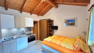 a small kitchen with a bed and a sink at Chalet Stadel in Saas-Grund