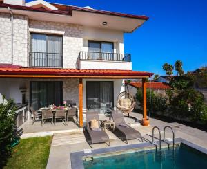 a villa with a swimming pool and a patio at Villa Lidya in Dalyan