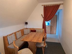 a dining room with a wooden table and chairs at Pension Haus Pentacon in Kurort Altenberg