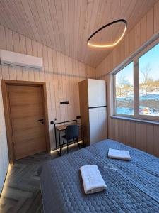 a bedroom with a bed with two towels on it at Evelin in Maidan Village +61 photos