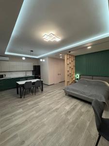 a bedroom with a bed and a table and chairs at Evelin in Maidan Village