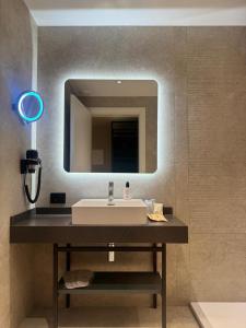 a bathroom with a sink and a mirror at Hotel Vitruvio in Milan