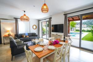 a living room with a table and a couch at Villa Lidya in Dalyan