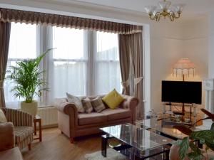 a living room with a couch and a coffee table at Sandfield The Promenade in Southport