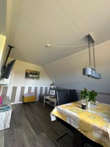 a dining room with a table and chairs at Ferienwohnung Wildblume in Fehmarn