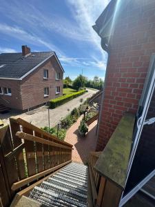 a balcony with a wooden railing and a brick building at Ferienwohnung Wildblume in Fehmarn