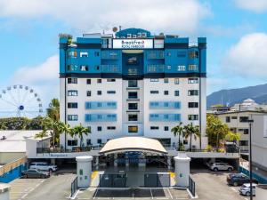a large blue and white building with a ferris wheel at BreakFree Royal Harbour in Cairns