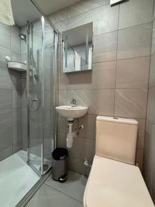 ein Badezimmer mit Dusche, Toilette und Waschbecken in der Unterkunft The Queensbury Hotel in Brighton & Hove