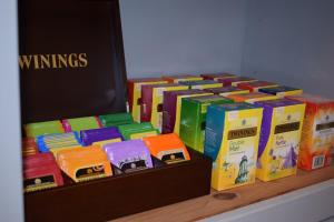 a bunch of books sitting on a shelf at Woodlyn Guest House in Gatehouse of Fleet