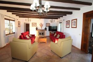 a living room with two couches and a tv at Loma la Parra in Valle de Abdalagís