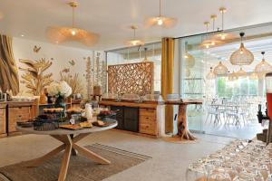 a kitchen with a table with food on it at Hôtel San Lucianu in Moriani Plage