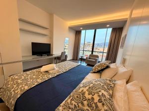 a hotel room with a bed and a television at Unit For Living in Beirut