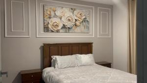 a bedroom with a bed with a painting on the wall at Upendo Apartment 2 Bedroom in Tilisi in Gatimu +49 photos