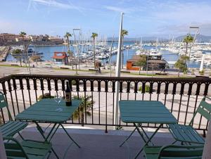 a table and chairs on a balcony with a marina at L'Aragosta Guesthouse in Alghero