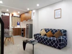 a living room with a couch and a table at Lukali Staycation in Tagbilaran City