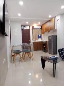 a kitchen with two chairs and a glass table at Lukali Staycation in Tagbilaran City +1 photo