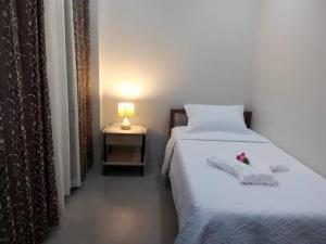 a bedroom with a bed with a flower on it at Lukali Staycation in Tagbilaran City