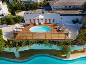 an aerial view of a swimming pool with a deck and a swimming poolvisor at Viva Heavens by Wyndham, A Trademark All Inclusive in San Felipe de Puerto Plata