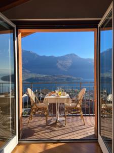a dining room with a table and chairs on a balcony at Casa Sole in Vercana