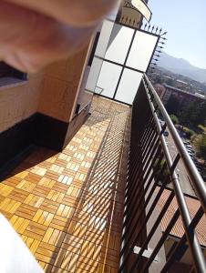 a person standing on a balcony looking down at a building at la casa di Titty con wi fi in Avellino