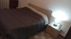 a bedroom with a bed and a nightstand with two lights at la casa di Titty con wi fi in Avellino
