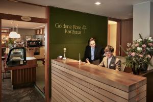 two people sitting at a counter in a restaurant at Goldene Rose Karthaus a member of Small Luxury Hotels of the World in Senales +66 photos
