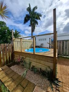 a deck with a plunge pool in a backyard at Cozy house with sea view! in Luquillo