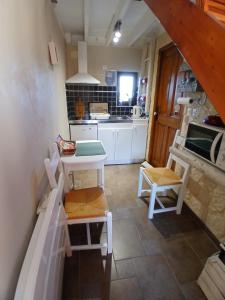 a kitchen with a table and chairs in a room at les alouettes in Leschelles +23 photos
