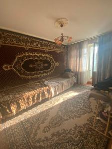 a bedroom with a bed with a ornate head board at Апартаменты м Южне in Sychavka