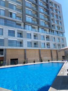 a swimming pool in front of a building at Golden LUX in Bar