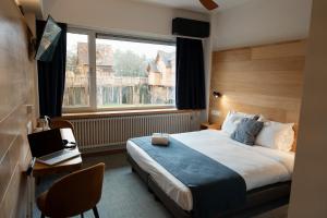 a hotel room with a bed and a window at Mont-des-Pins in Durbuy +139 photos