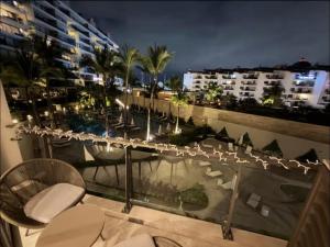a balcony of a hotel with chairs and a table at Nima bay in Puerto Vallarta