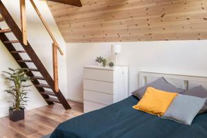 a bedroom with a bed with a wooden ceiling at Rigó Ház - Kisoroszi in Kisoroszi