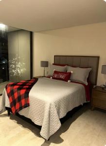 a bedroom with a large bed with red and black pillows at Nima bay in Puerto Vallarta +7 photos
