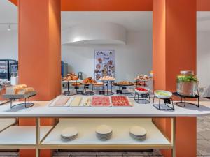 a buffet with many different types of food on display at B&B HOTEL Milano Cologno Studios in Cologno Monzese