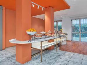 a buffet line with a bowl of fruit on it at B&B HOTEL Milano Cologno Studios in Cologno Monzese
