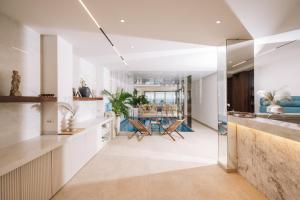 a kitchen with white cabinets and a dining room at Senator Lux in Ulcinj