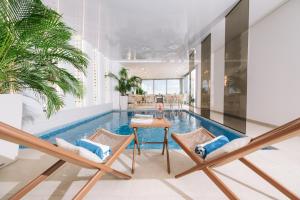 a living room with a pool and two chairs and a table at Senator Lux in Ulcinj