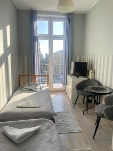 a hotel room with two beds and a window at FRESCO PLUS -Filharmonia in Łódź