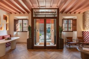 a lobby with a glass door and cactus at Marton Turisme de Interior in Valldemossa