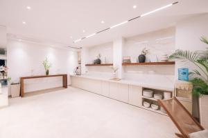 a large white salon with a counter and plants at Senator Lux in Ulcinj +284 photos