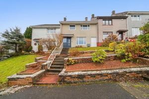 a house with stairs in front of a yard at 3-Bed Home in East Kilbride Ideal for Contractors & Longer Stays from Voyage Collection in East Kilbride