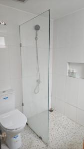 a bathroom with a shower and a toilet at Abagta Kosan in Jakarta