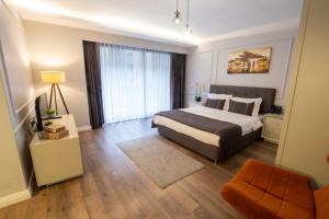 a bedroom with a bed and a couch and a window at Myway Deluxe Hotel in Konak