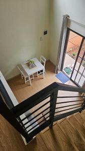 a table and chairs in a room with a window at Abagta Kosan in Jakarta