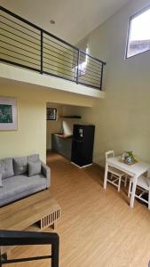 a living room with a couch and a loft at Abagta Kosan in Jakarta