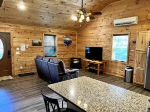 a log cabin living room with a table and chairs at Little Elk Cabin in Banner Elk